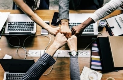 colleagues giving fist bump